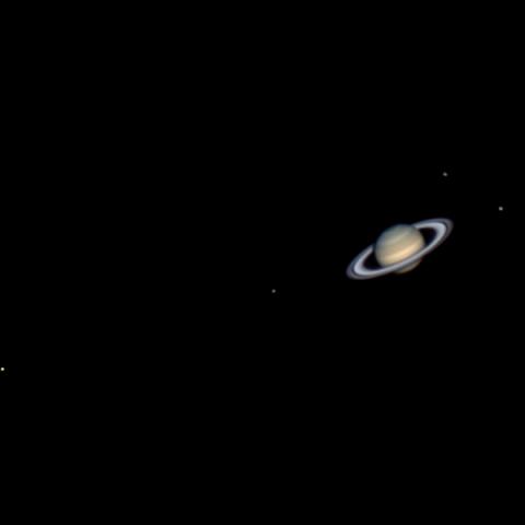 photo of saturn and four moons