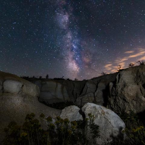 photo of the milky way above some rock formations