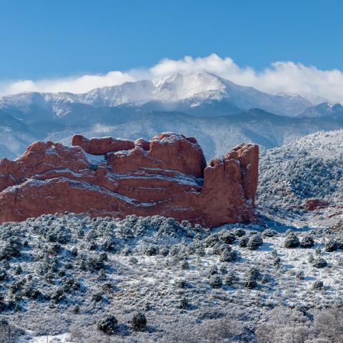 photo of mountains and rock formations covered in snow