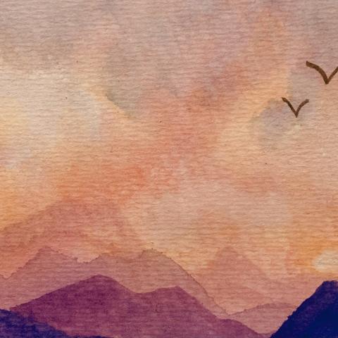 A photograph of a watercolor painting of birds flying above a mountain range at sunset