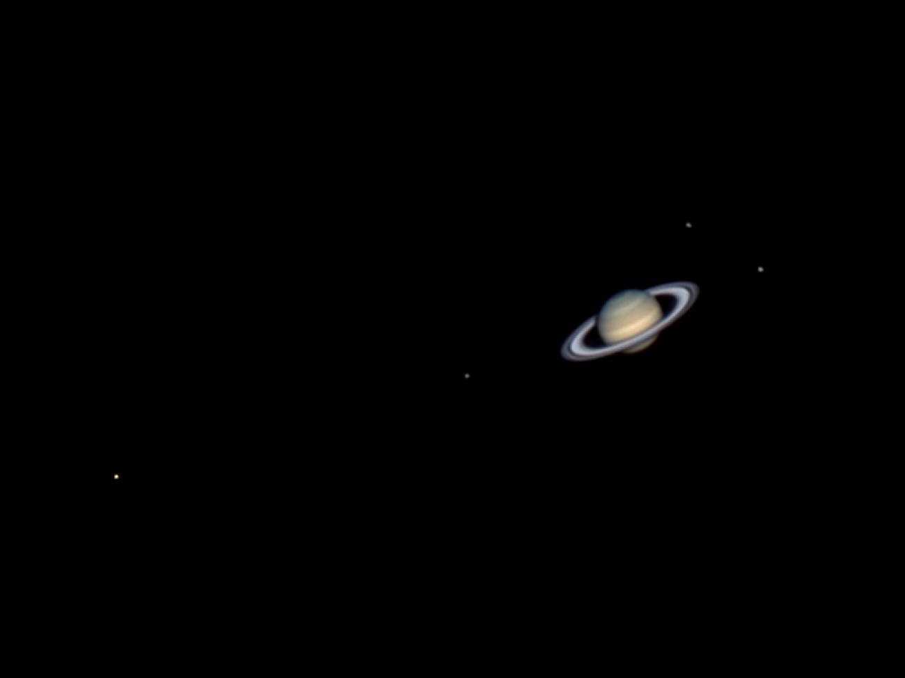 photo of saturn and four moons