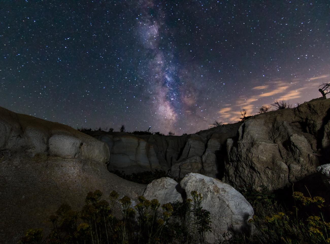 photo of the milky way above some rock formations