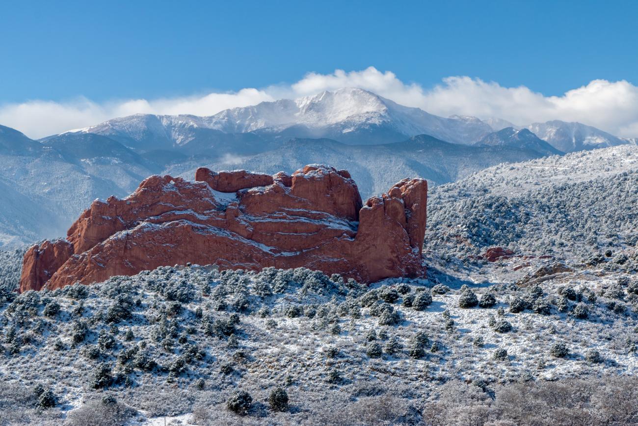 photo of mountains and rock formations covered in snow